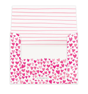 The E. FRANCES PAPER - DOGGIE DRESS-UP CLASSROOM VALENTINE SET features three dogs dressed festively: one in striped pajamas, another with a heart bandana, and a third with heart antennae. “Happy Valentine’s Day!” is displayed across the top against a backdrop of pink hearts, ideal for charming Valentines or envelopes.