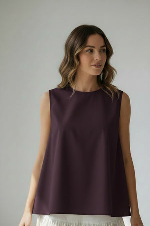 A close-up of the MEIMEIJ Sleeveless Cotton Top reveals dark cotton poplin fabric with textured, subtle horizontal lines and a slightly uneven surface in a deep, muted purple shade.