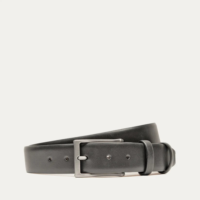 A close-up of the WILL LEATHER GOODS - GLAZED CALFSKIN BELT IN BLACK showcases its black glazed calfskin and five adjustment holes, set against a white background.