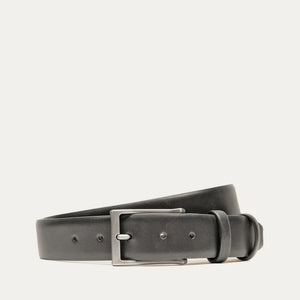 A close-up of the WILL LEATHER GOODS - GLAZED CALFSKIN BELT IN BLACK showcases its black glazed calfskin and five adjustment holes, set against a white background.