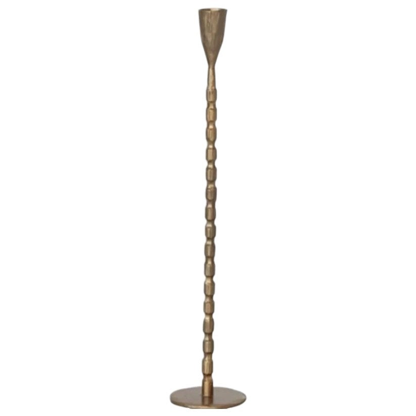 The CREATIVE COOP CAST IRON TAPER HOLDER IN BRASS FINISH, MEDIUM features a sleek, textured stem and round base, bringing elegant style to any setting.