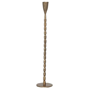 The CREATIVE COOP CAST IRON TAPER HOLDER IN BRASS FINISH, MEDIUM features a sleek, textured stem and round base, bringing elegant style to any setting.