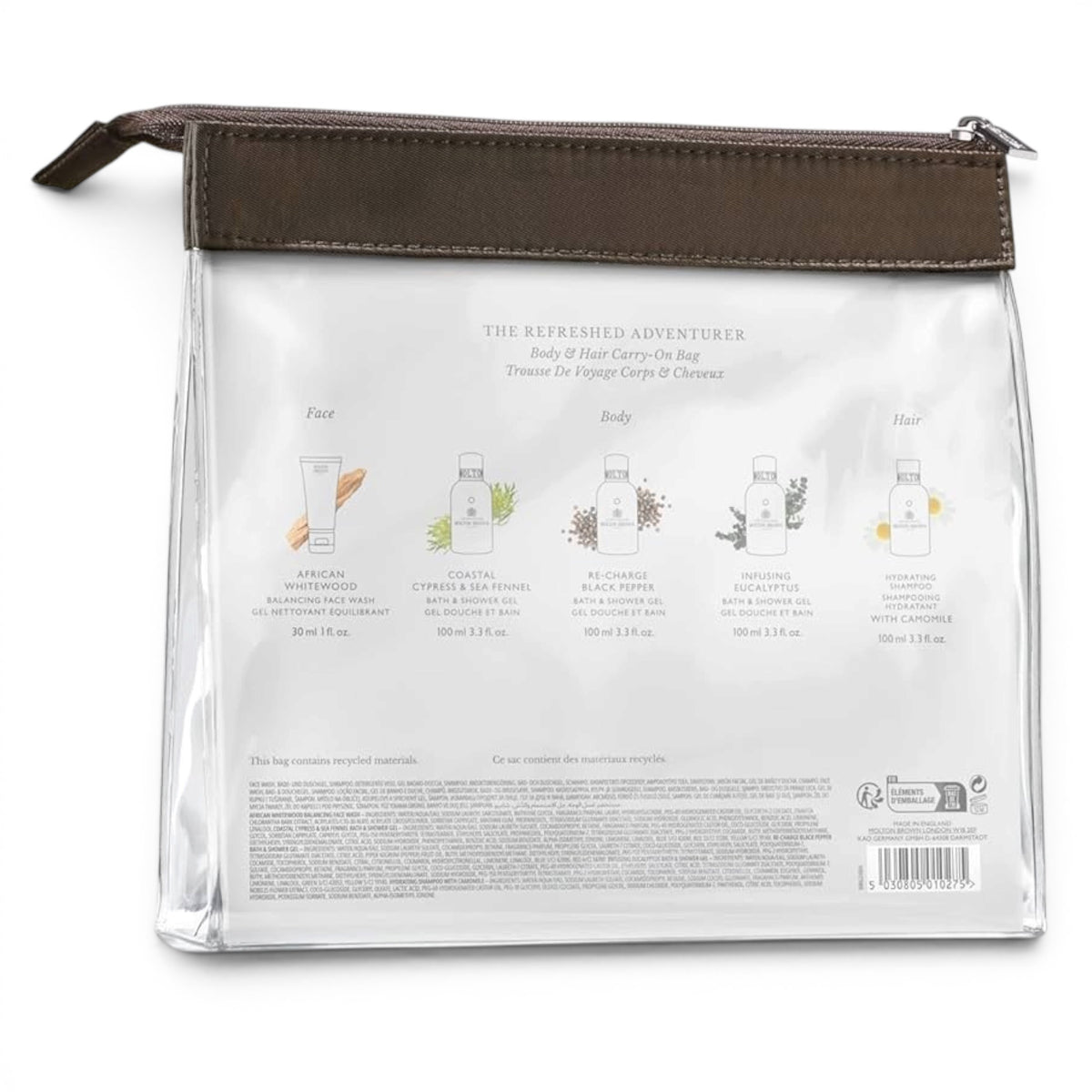 The MOLTON BROWN Refreshed Adventurer Body & Hair Carry-On Bag includes a clear bag with brown zipper, four color-labeled travel-size bath and shower gels, and a blue face wash tube on the left—a stylish set for travel from MOLTON BROWN.