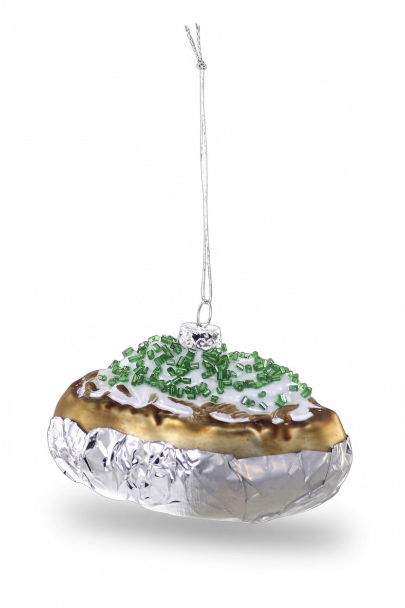 A BAKED POTATO ORNAMENT shaped like a loaded baked potato topped with sour cream and chives, wrapped in foil.
