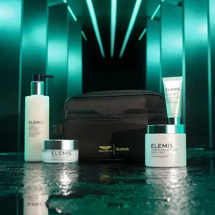 The ELEMIS – ASTON MARTIN DELUXE SKINCARE COLLECTION by ELEMIS – STEINER features a green gift box, black toiletry bag, and four luxury skincare products—including the Dynamic Resurfacing Facial Wash—against a white background.