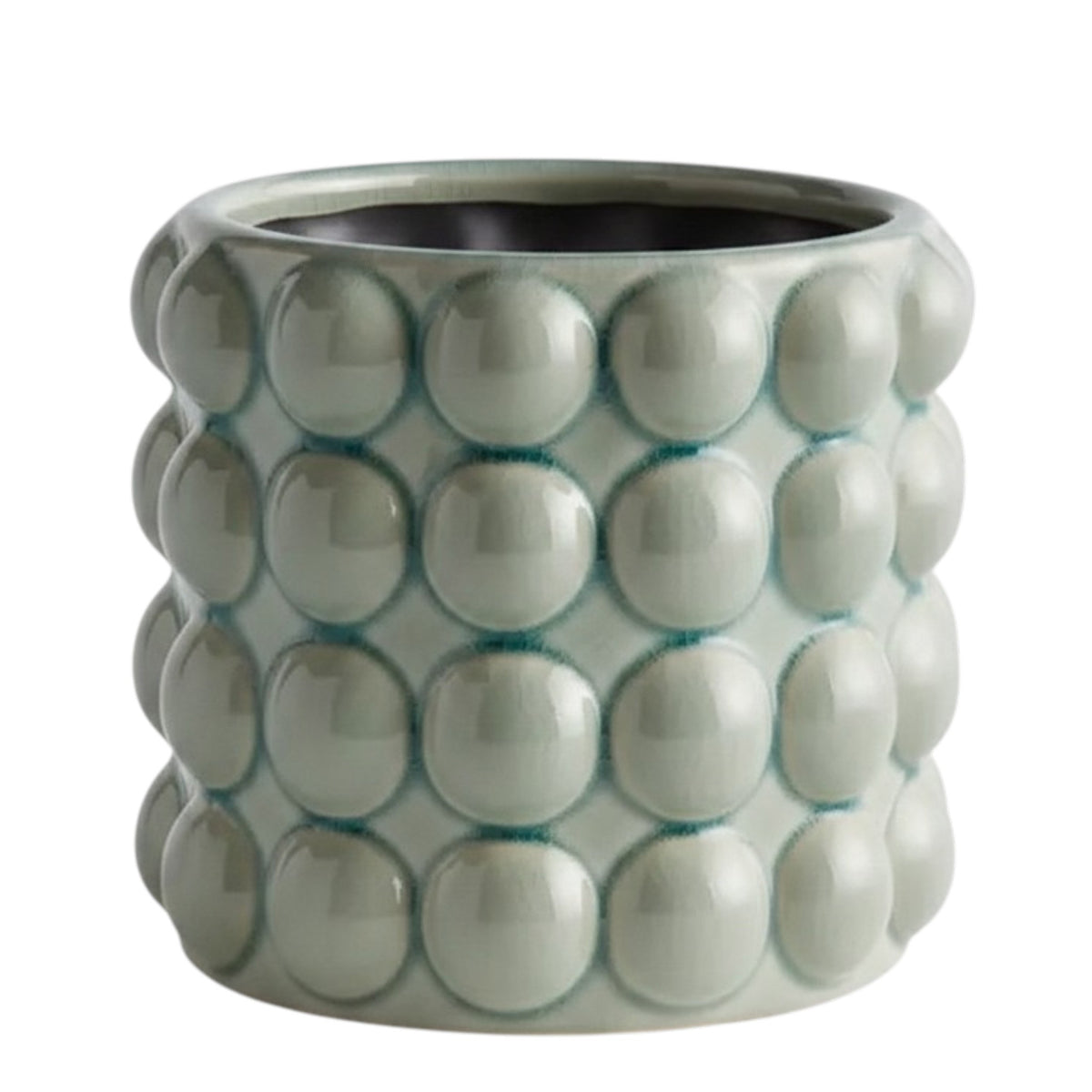 The NAPA HOME AND GARDEN - VALENCIA POT, LARGE is a round ceramic planter by NAPA HOME AND GARDEN, featuring a glossy seafoam glaze and a raised, bubble-like pattern on the exterior. This contemporary planter is light grey-green in color and is shown empty against a white background.