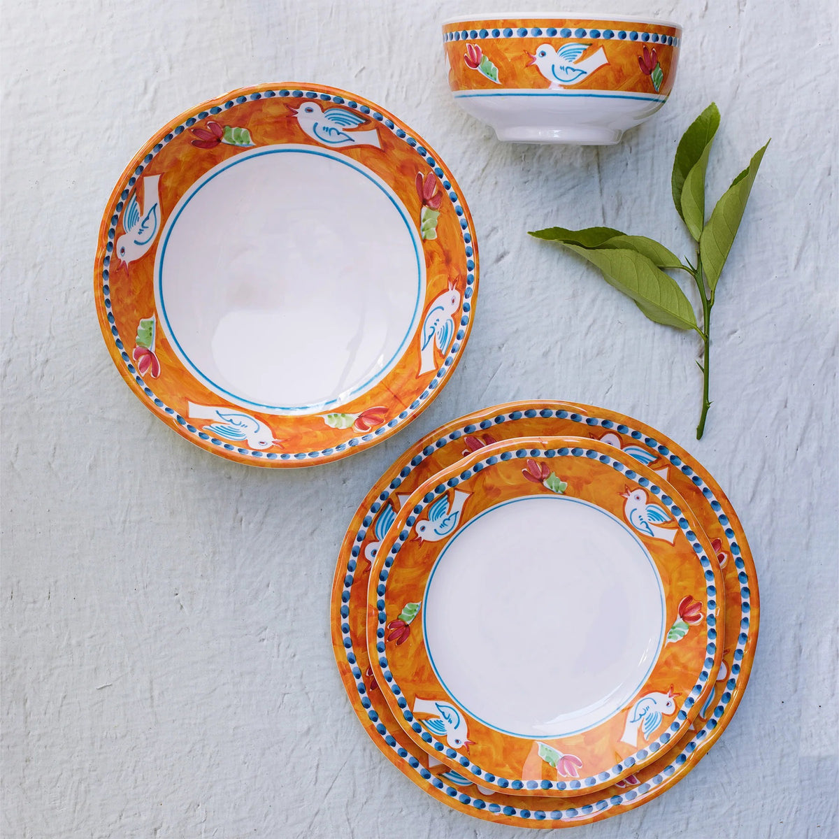 The VIETRI Melamine Campagna Pasta Bowl features a red interior with playful pig and fruit designs, a blue patterned edge, and a durable white melamine build—perfect for outdoor dining.