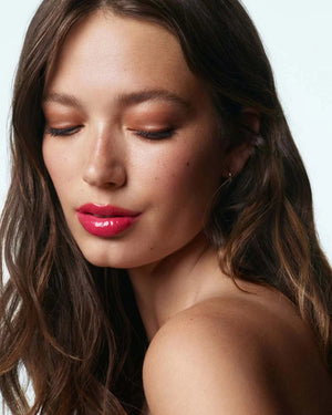 A 15ml tube of U BEAUTY THE PLASMA LIP COMPOUND, a plumping lip treatment with light gray packaging and white branding, stands upright against a white background.