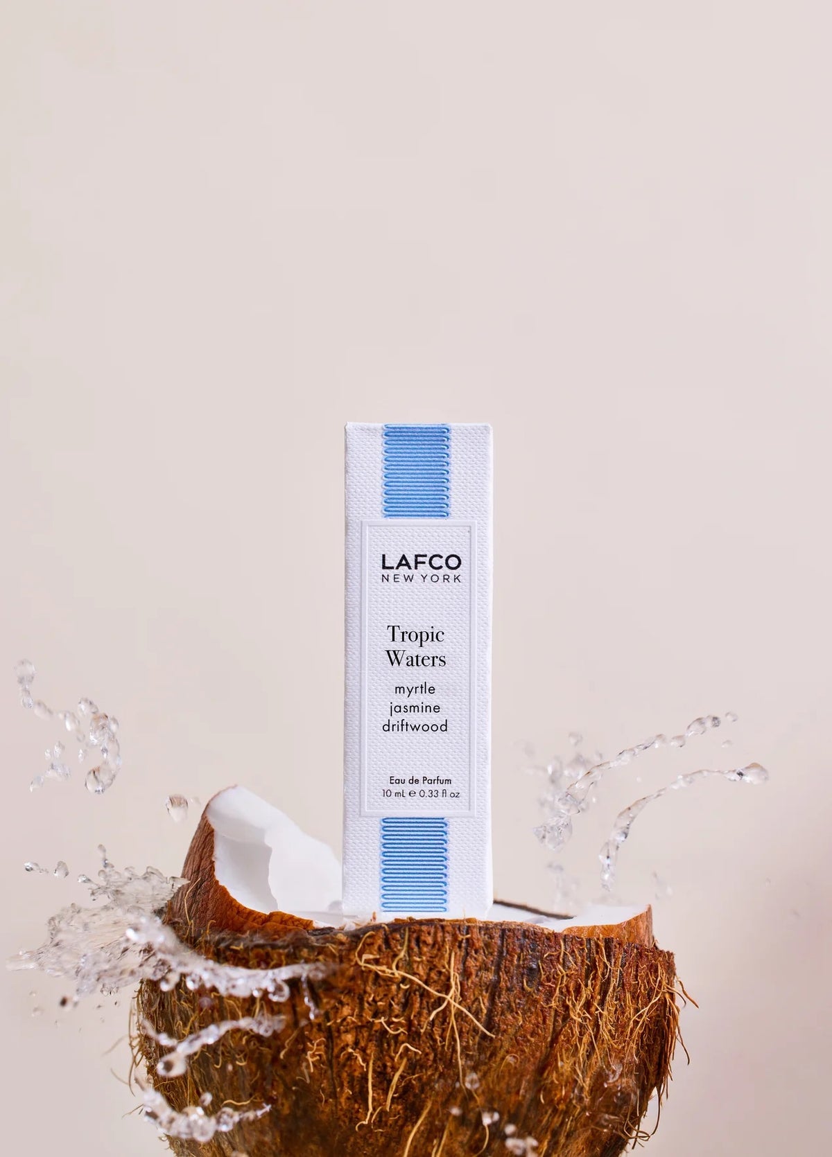 A clear glass 10ml perfume bottle labeled “LAFCO Fine Fragrance, Tropic Waters” with a marbled blue cap, displayed against a white background. This vegan and cruelty-free fragrance from LAFCO evokes the essence of coconut water for a refreshing tropical scent experience.