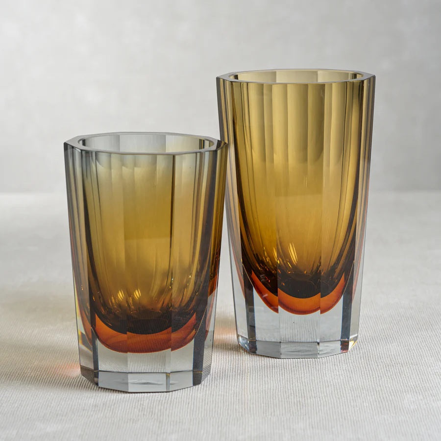 The CORVATSCH Amber and Smoke Tonal Glass Vase by ZODAX features a tall, faceted silhouette with a smoked amber tone that gently transitions to clear at the base—an elegant and contemporary 8.25” vase perfect for enhancing your home decor.