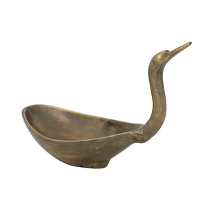 The CREATIVE COOP BIRD SHAPED BOWL IN ANTIQUE BRASS FINISH features a cast aluminum body with an elongated neck and beak, resembling a crane or heron for a stunning decorative accent.