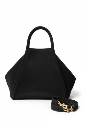 The OLIVEVE Taya Top Handle Crossbody in black Italian leather-backed suede is showcased on a white background. With angular sides, short handles, and a detachable crossbody strap featuring gold clasps, this elegant design blends style and versatility.