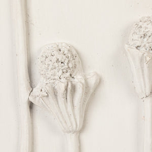 The CREATIVE COOP WOOD FRAMED PLASTER CAST BOTANICAL WITH JUTE MAT features four raised flower stems on a rectangular white panel, adding botanical wall art charm to any room.