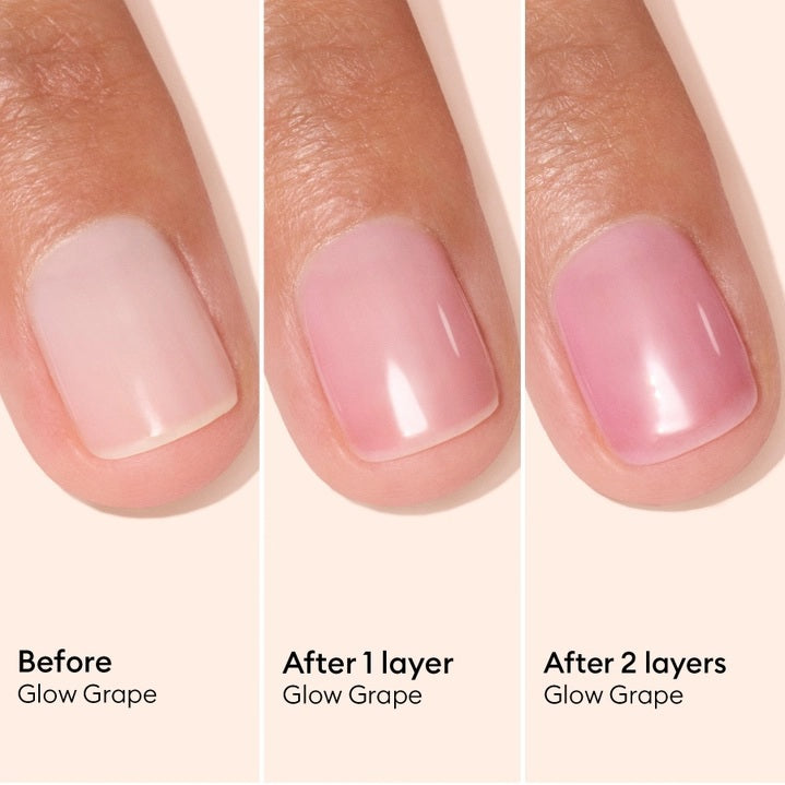 A pink serum drop labeled with its ingredients: raspberry extract (strengthens nails), AHAs (restore and harden), and sweet almond oil (nourishes). The text highlights that MANUCURIST - ACTIVE GLOW CARE POLISH by MANUCURIST INC is 85.5% plant-based—making it the ideal nail strengthener for achieving healthy, glass-like nails.