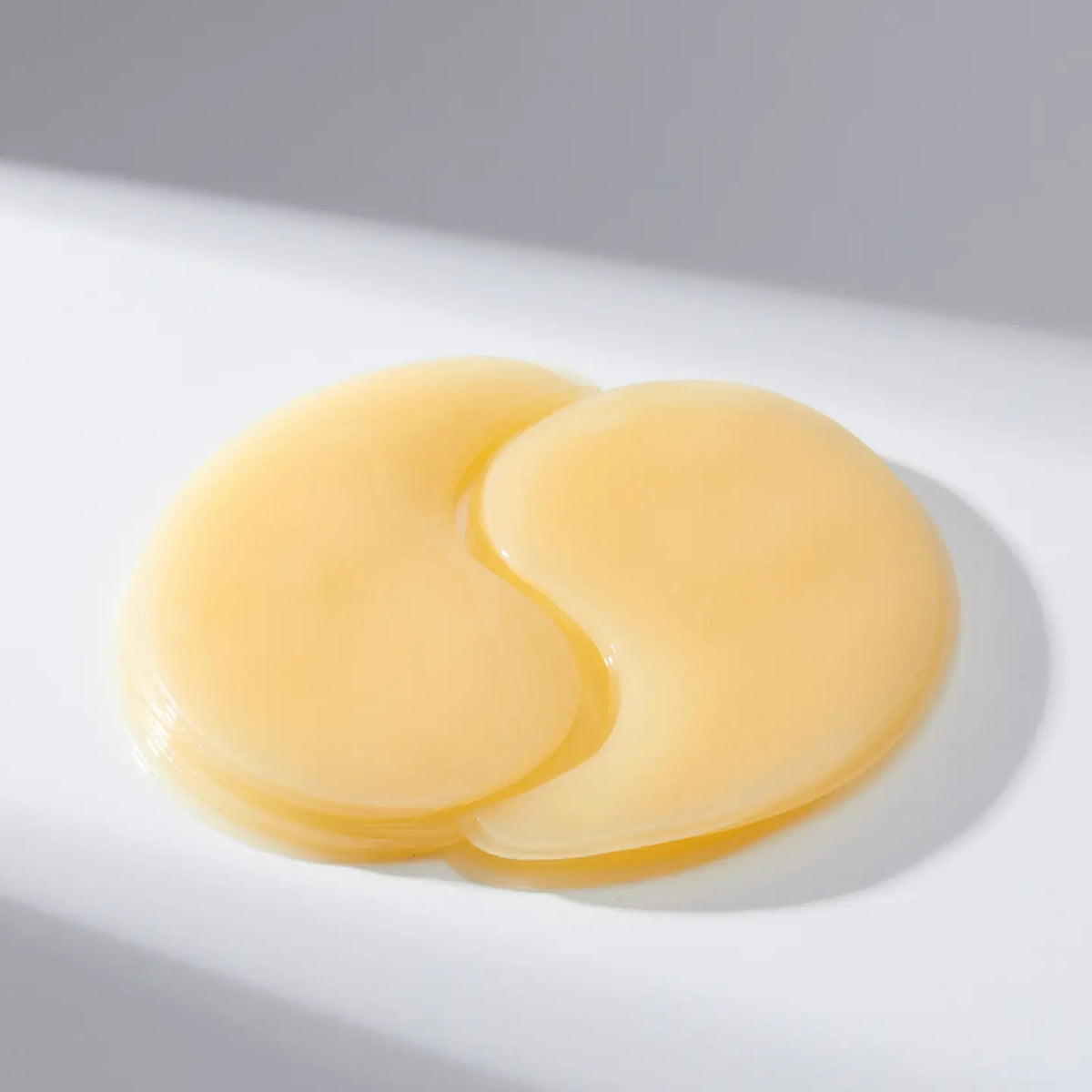 A white-background features a yellow container of EXOD INTERNATIONAL&#39;s MEDIHEAL - VITA COLLAGEN EYE AMPOULE PATCH 60PC, designed to enhance hydration and reduce eye wrinkles with its collagen-rich formula.