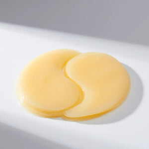 A white-background features a yellow container of EXOD INTERNATIONAL's MEDIHEAL - VITA COLLAGEN EYE AMPOULE PATCH 60PC, designed to enhance hydration and reduce eye wrinkles with its collagen-rich formula.