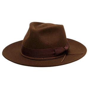 The WYETH - TEDDY HAT IN BROWN by WYETH is a vintage-inspired wide-brimmed fedora with a matching dark brown ribbon band, shown against a plain white background.