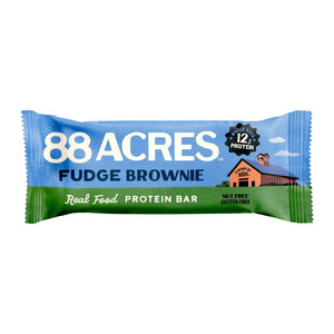 An 88 ACRES Fudge Brownie High Protein Bar is displayed on a white background. The wrapper, predominantly white with blue accents, showcases images of the bar and its ingredients, emphasizing that it is a nut-free protein bar from 88 ACRES.