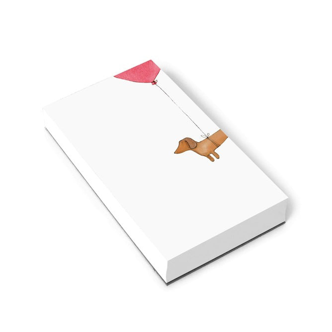 The E. FRANCES - NOTEPAD HOTDOG HIGH by E. FRANCES PAPER features a brown dachshund tied to a red heart balloon on a white background—ideal for pet lovers&#39; stationery and proudly made in the USA.