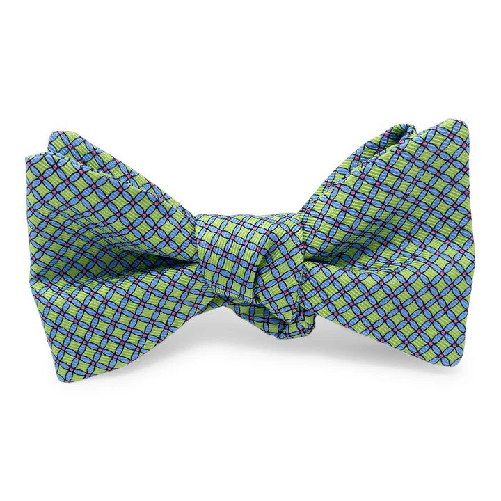 The PETER-BLAIR Cushions Silk Bow Tie in Green by BIRD DOG BAY features a light green handmade design with a blue and red checkered pattern, displayed on a white background.