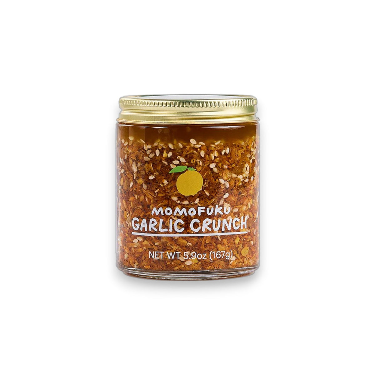 A 5.9 oz (167 g) jar of MOMOFUKU Garlic Crunch features a gold lid, an orange graphic above "Momofuku Garlic Crunch," and includes chef-approved garlic condiment with visible chili flakes.