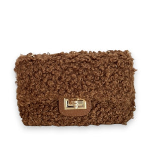 The VICARIO CINQUE Brescia Bag in brown by VICARIO CINQUE showcases a soft, curly bouclé texture with a modern rectangular gold clasp on the front, embodying Italian-inspired chic style and contemporary elegance.