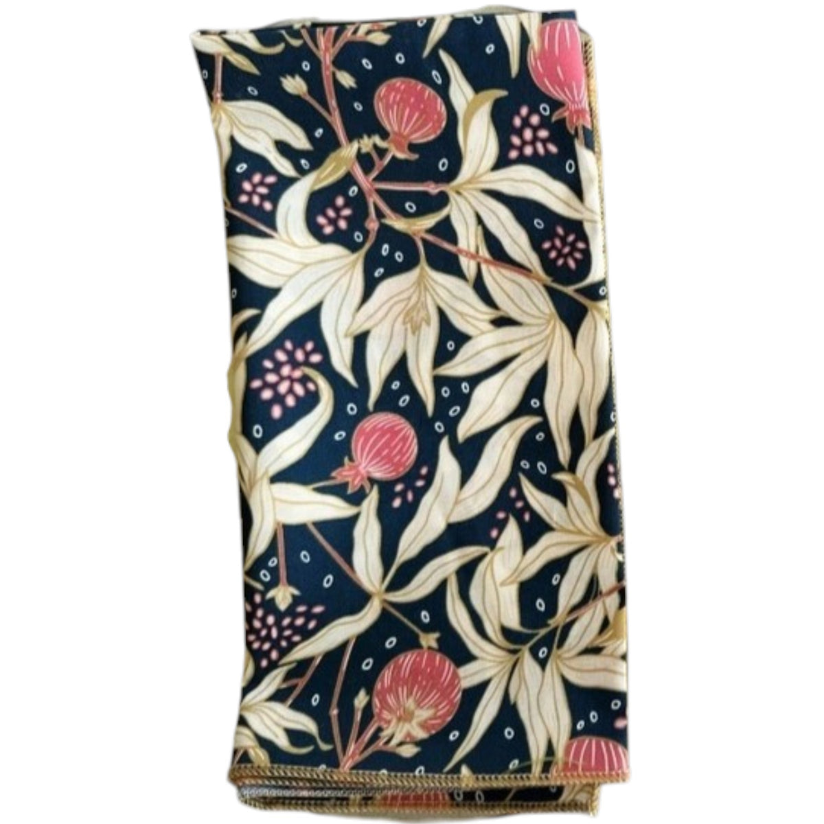 Two transparent plates, one yellow and one pink, rest on a light surface. Each displays DOT AND ARMY's Gooseberry Dinner Napkin—a dark blue cotton napkin with a beige, red, and green leaf pattern for stylish sustainable dining.