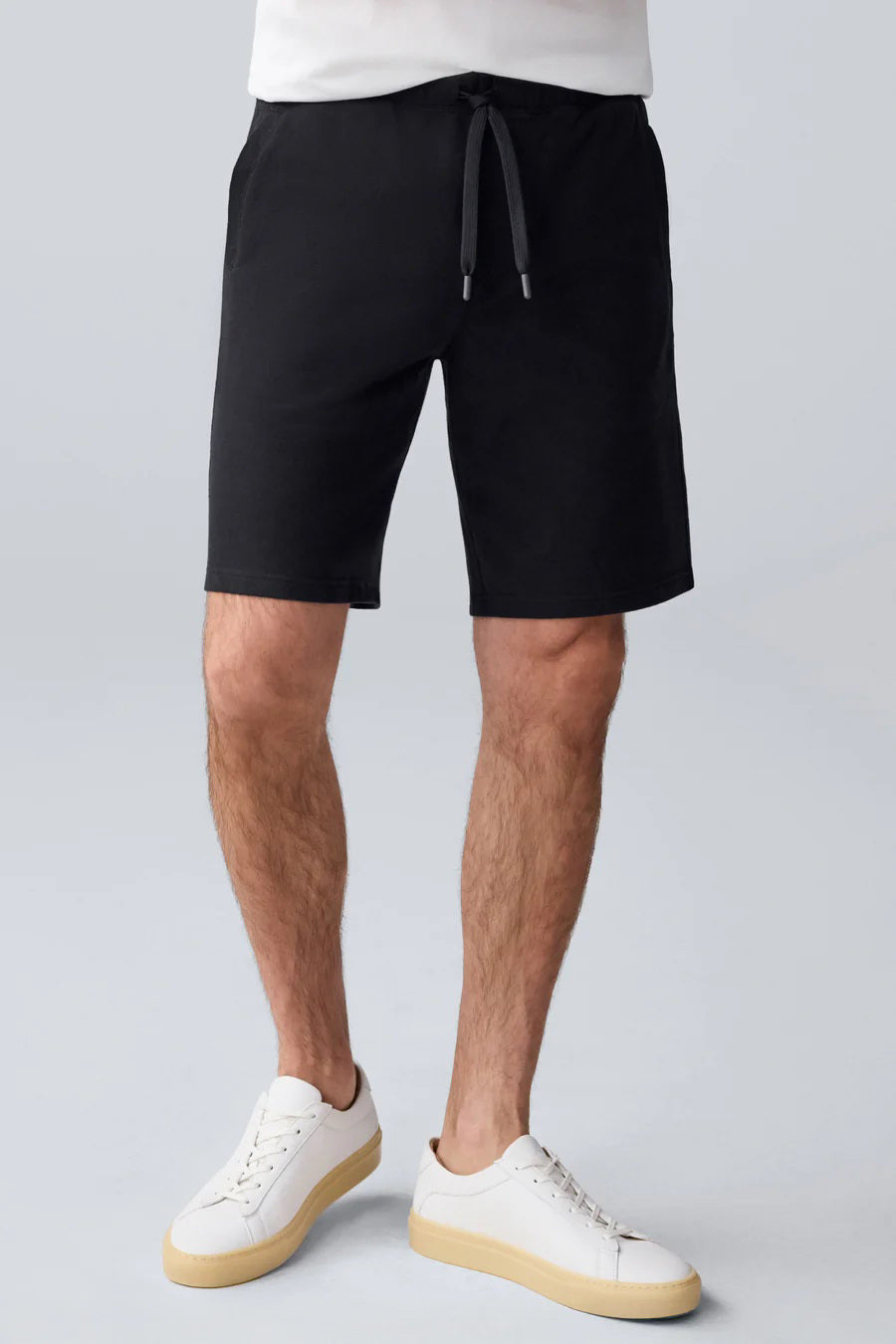 The MACK WELDON ACE Sweatshort 9" in navy features French terry fabric, side pockets, an elastic waistband, a tailored fit, and inner "Mack Weldon" branding—all laid flat on a white background for a polished look.