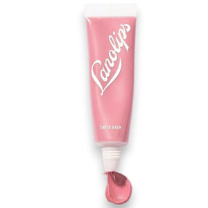 Two forearms with four swatches of LANOLIPS - TINTED LANOLIN LIP BALM IN ROSE shades—Rose, Rhubarb, Perfect Nude, and Spice—display color differences on different skin tones against a light background. Each shade from LANOLIPS offers a look reminiscent of a sheer color lip tint or the subtle hydration delivered by this tinted lanolin lip balm.