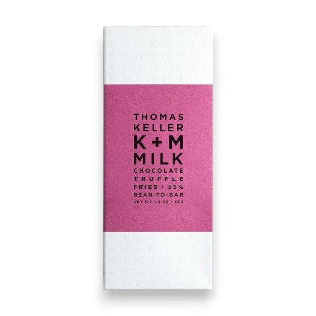A K+M - MILK CHOCOLATE TRUFFLE FRIES BAR by K &amp; M EXTRAVIRGIN CHOCOLATE, wrapped in white with a magenta label featuring black text, is a bean-to-bar milk chocolate crafted in Napa Valley and infused with the savory flavor of Truffle Fries for a uniquely distinctive treat.