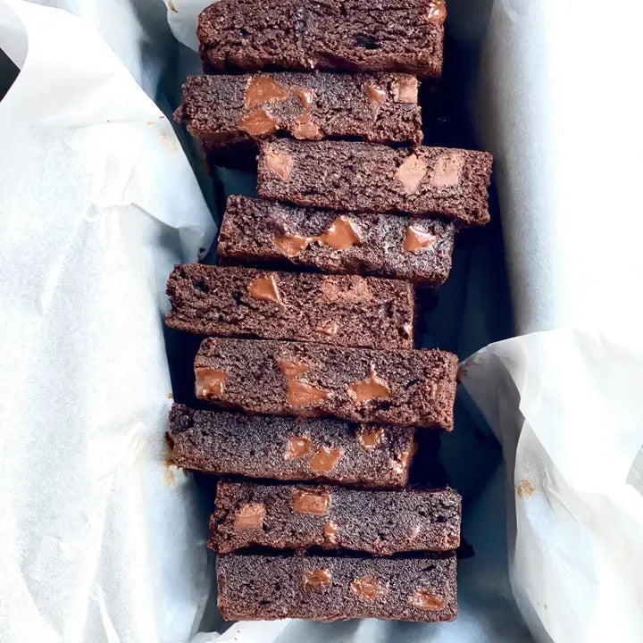 A white pouch labeled "MAISON ZOE FORD - BIG TIME BROWNIE MIX" features a clear window displaying rich, luxurious brownies with chunks inside. The packaging reads "Exceptional Baking Mixes - Meilleure Mélange À Cuisson", "12 Brownies," and has a net weight of 675g. Get ready to bake the best brownies worthy of Top Chef Canada!