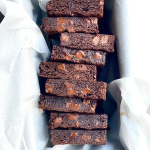 A white pouch labeled "MAISON ZOE FORD - BIG TIME BROWNIE MIX" features a clear window displaying rich, luxurious brownies with chunks inside. The packaging reads "Exceptional Baking Mixes - Meilleure Mélange À Cuisson", "12 Brownies," and has a net weight of 675g. Get ready to bake the best brownies worthy of Top Chef Canada!