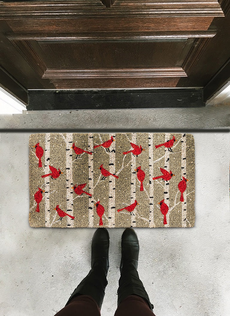 Rectangular CARDINALS IN BIRCH DOORMAT by ABBOTT, featuring a pattern of red cardinals perched on birch tree branches.