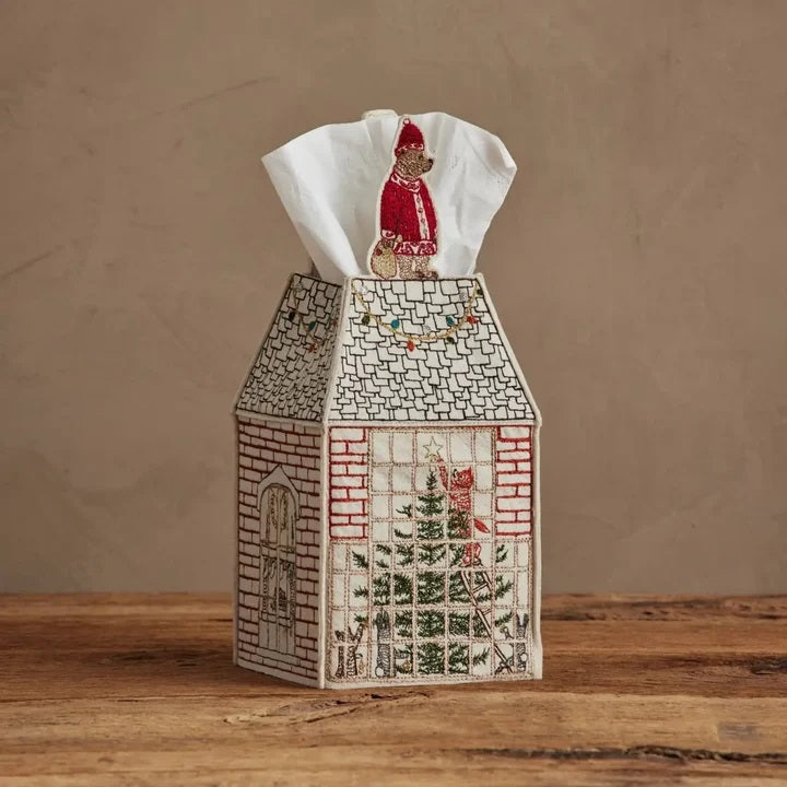 HOME FOR THE HOLIDAYS TISSUE BOX COVER shaped like a house, featuring an embroidered Christmas tree, string lights, and a teddy bear in a Santa hat for festive holiday home decor.