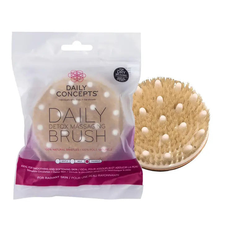 A DAILY CONCEPTS DETOX MASSAGE BRUSH is pictured. The brush, with natural bristles and a light wooden backing, promises smoother, softer skin. The packaging next to it highlights benefits, including helping to reduce cellulite deposits.