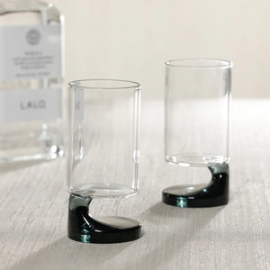The ZODAX NAPOLI SHOOTER GLASS features a modern cylindrical clear body and a distinctive smoke base, shown against a white background.