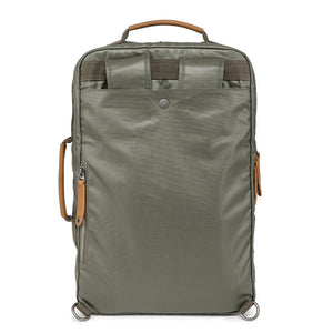 The TSD BRAND Madrone Coated Canvas Backpack in army green features brown leather accents, zippers, a top flap, side handles, metal rings, and a leather logo patch; shown lying flat to display these details.