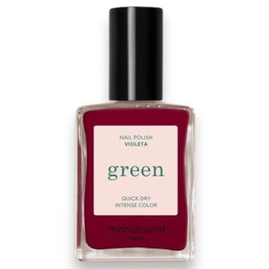 A bottle of MANUCURIST - GREEN™ Nail Polish in Violeta from MANUCURIST INC features a deep pinky purple shade, a black cap, and a label highlighting “green” and “quick dry intense color.”.