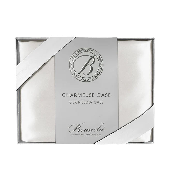 The BRANCHE - CHARMEUSE PILLOW CASE SILK comes boxed with a gray label and pink ribbon, stating “BRANCHE Sleep Luxury. Wake Up Beautiful.” Designed to reduce hair frizz and prevent wrinkles.