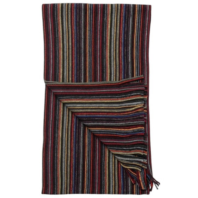 The AMANDA CHRISTENSEN Multi-Stripe Knitted Wool Scarf in Black features a rib-knit construction with vertical multicolored stripes and fringe at one end, showcasing vibrant shades of red, blue, orange, yellow, and black.