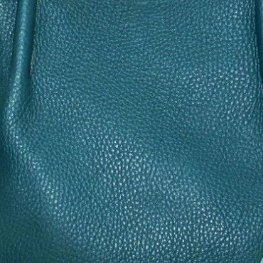 The OLIVEVE Sutton Convertible Satchel, in black Mediterranean buffalo cowhide leather, features two handles and gold hardware on a white background. It boasts a textured surface and has a secure zip closure.