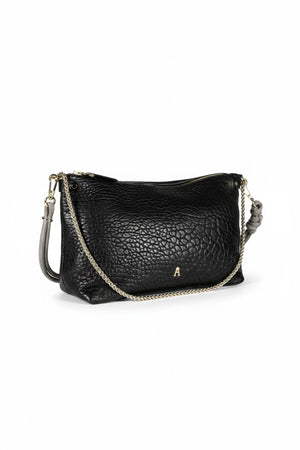 The CRAIE STUDIO - MALLOW BUBBLE NOIR HANDBAG features black bubble leather, a luxurious gold zipper, and an elegant gold chain strap. Displayed against a white background, this chic piece from CRAIE STUDIO adds sophisticated style to any outfit.