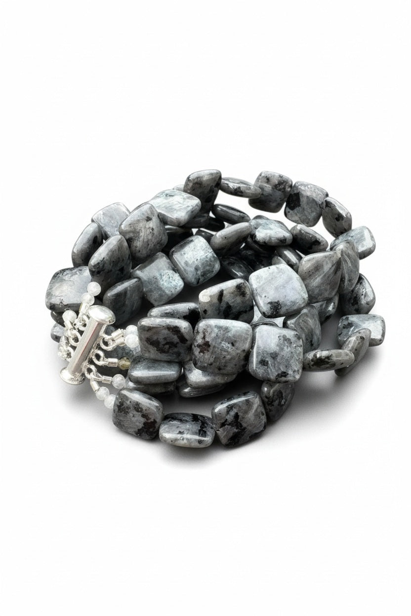 Introducing the ANN LIGHTFOOT - LARKIVITE LARGE SQUARE FIVE STRAND BRACELET, a bold statement piece featuring five strands of chunky, polished gray and black marbled larvikite stones. This ANN LIGHTFOOT bracelet is finished with a silver slide clasp embellished with small decorative beads.