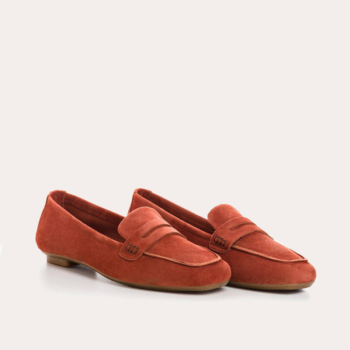 Top view of the REQINS - HEMA Suede Loafer in Briques, featuring a penny strap and visible stitching, highlighting the refined design of women’s loafers by REQINS against a plain white background.