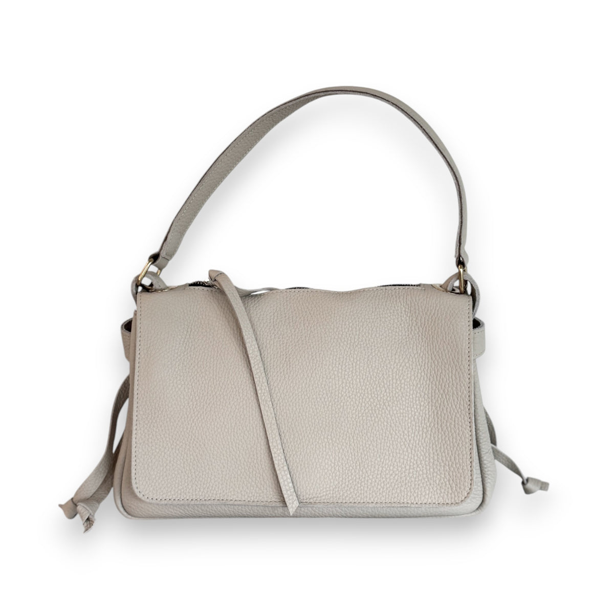 The OLIVEVE Remi Medium Slouchy Shoulder Bag in Lamp Buffalo Cowhide features a textured light beige leather, flap closure, short handle, and detachable crossbody strap, shown on a white background.