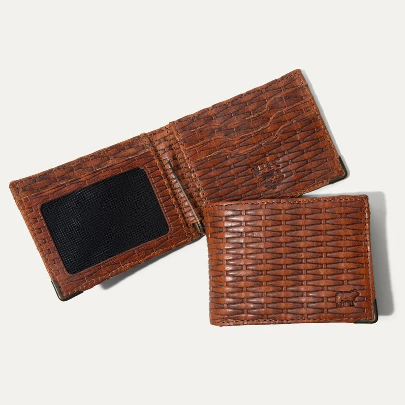 The WILL LEATHER GOODS - THE INDUSTRIALIST BILLFOLD IN COGNAC BASKETWEAVE, made from full-grain leather with a woven texture, shows an empty ID slot with a black mesh window on the left. The wallet rests open on a light surface.