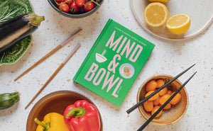 Book cover for MIND & BOWL: A GUIDE TO MINDFUL EATING & COOKING BY JOEY HULIN from PETITECOLLAGE featuring a bowl of noodles and a bowl of food on a green background. The pink text reads: "A Guide to Mindful Eating & Cooking. Mind & Bowl. Joey Hulin." Ideal for those interested in mindful eating, this book from PETITECOLLAGE encourages readers to explore the relationship between mindfulness and food with inspiring, simple bowl recipes.