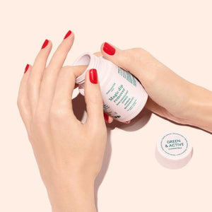 The MANUCURIST - MAGIC DIP REMOVER by MANUCURIST INC comes in a white plastic 70 mL bottle with a screw-on cap, featuring green and pink text on the label. This acetone-free, vegan nail polish remover is designed to gently remove polish and is conveniently travel-friendly for use on the go.