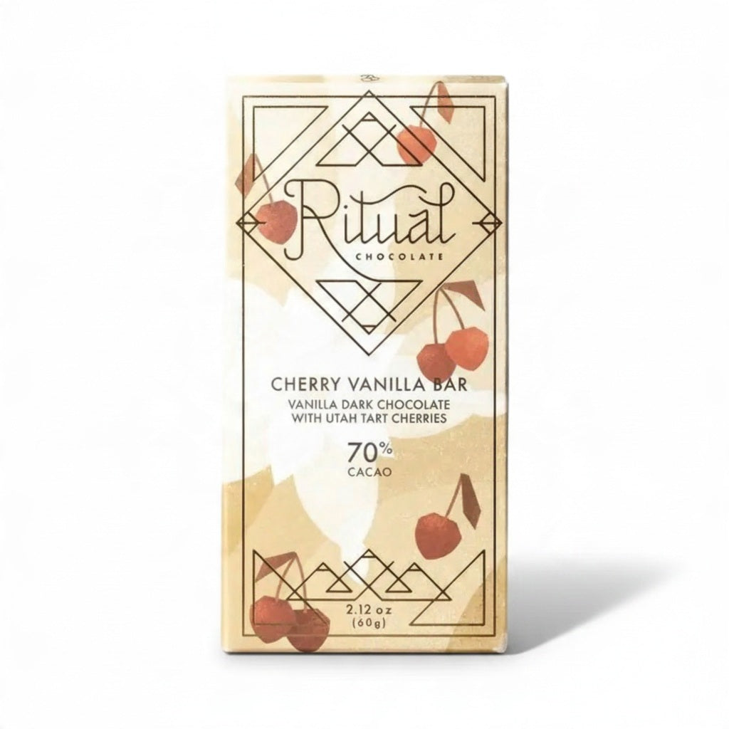 A beige RITUAL CHOCOLATE - CHERRY VANILLA DARK CHOCOLATE BAR 70% wrapper features geometric patterns, cherry art, and the text: "Vanilla Dark Chocolate with tart cherries, 70% Cacao, 2.12 oz (60g).