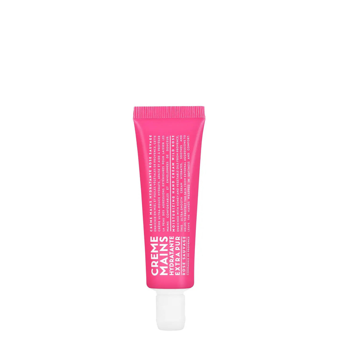 A small, bright pink tube of COMPAGNIE DE PROVENCE Travel Hand Cream Wild Rose 1oz by CIE LUXE BRANDS stands upright on a white background, featuring hydrating formula, subtle rose scent, white cap at the bottom, and white front text.